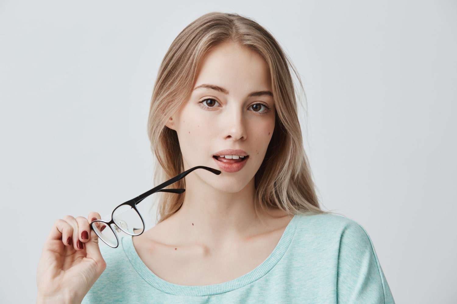 girl holding glasses